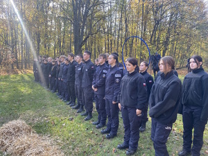 na zdjęciu klasa policyjna na terenie parku stojąca w dwuszeregu