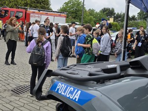 uczestnicy festynu profilaktycznego stoją przy policyjnym stanowiku