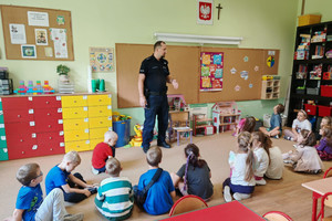 Na zdjęciu widoczny policjant z uczestnikami spotkania.