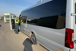 Na zdjęciu widać inspektora transportu drogowego przy autobusie.