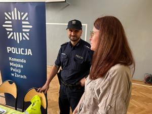 Na zdjęciu widać stanowisko promocyjne żorskiej Policji, policjanta oraz przedstawicielkę kadr.