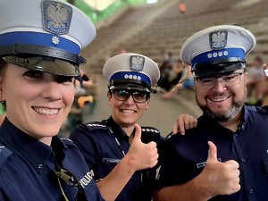 zdjęcie kolorowe typu selfie policjanta i dwóch policjantek pokazujących kciuk w górę